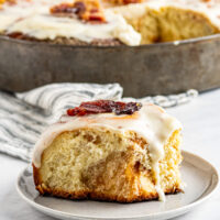 Bacon cinnamon roll on a plate.