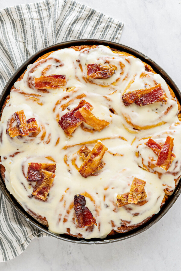 Cinnamon rolls with cream cheese icing and candied bacon.