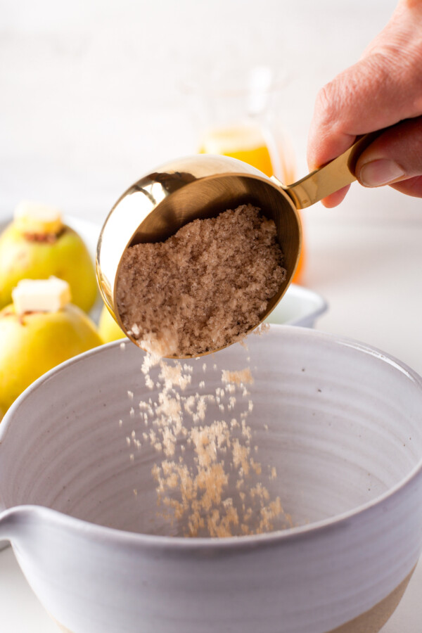 Brown sugar being poured into a mixing bowl.