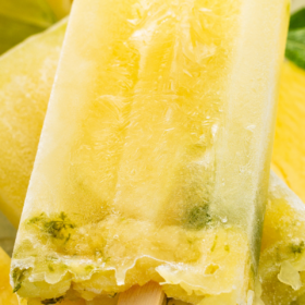 Pineapple popsicle with mint leaves inside.
