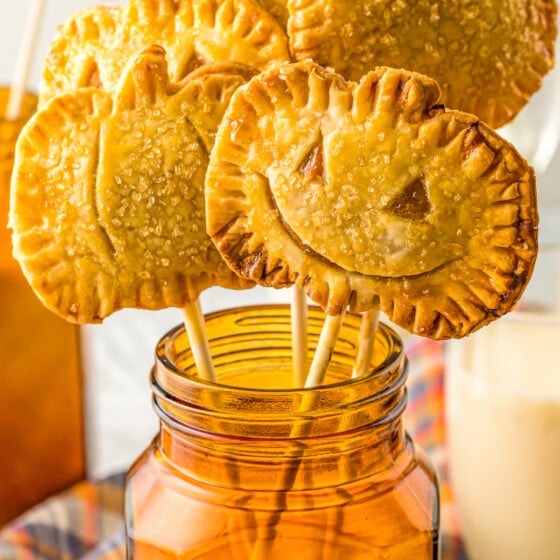 Pumpkin pie pops in a jar of sugar.