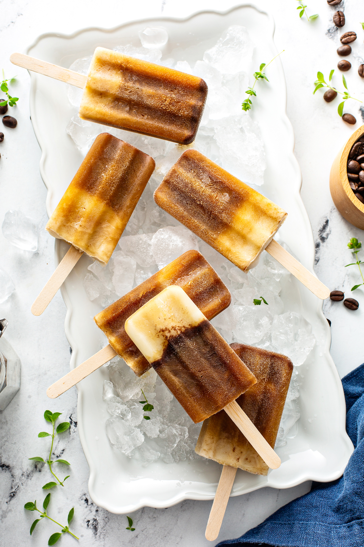 espresso popsicles on a white tray with ice