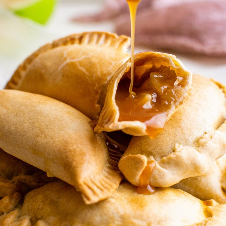 Caramel sauce drizzled over a plate of empanadas.