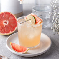 Grapefruit Paloma with fresh grapefruit wedges.
