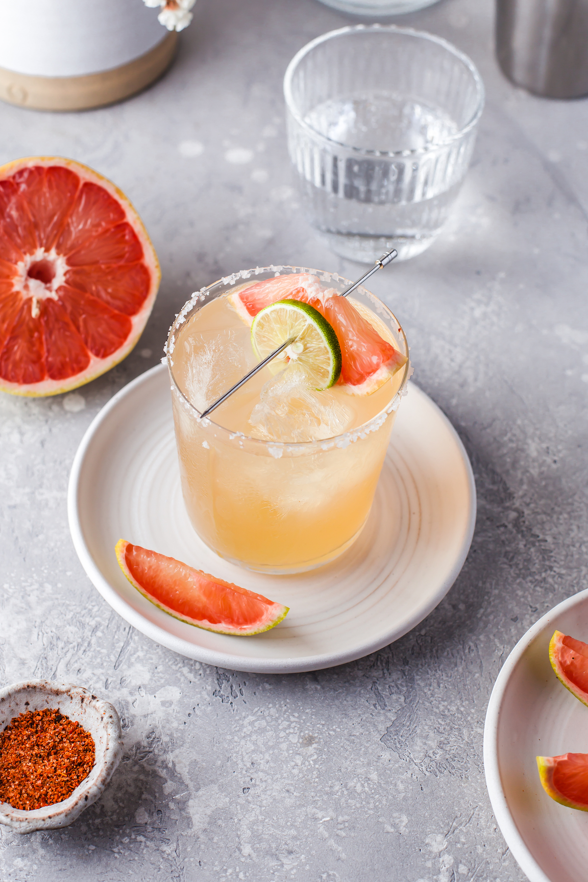 A grapefruit Paloma cocktail on a plate.
