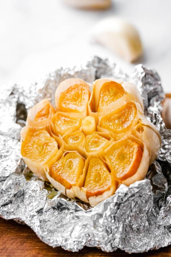 Golden roasted garlic presented in crinkled garlic.