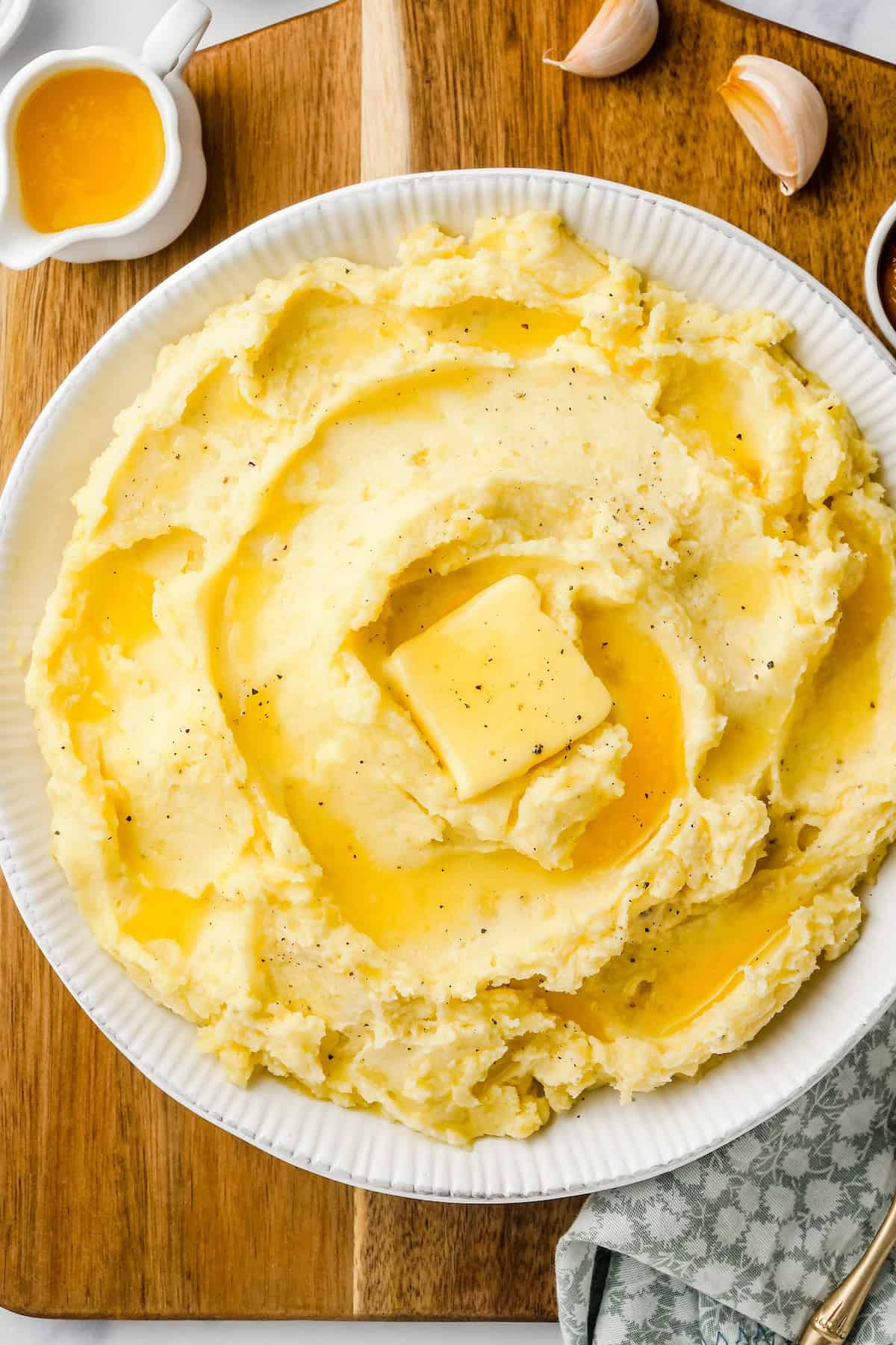 Creamy garlic mashed potatoes are topped with butter.