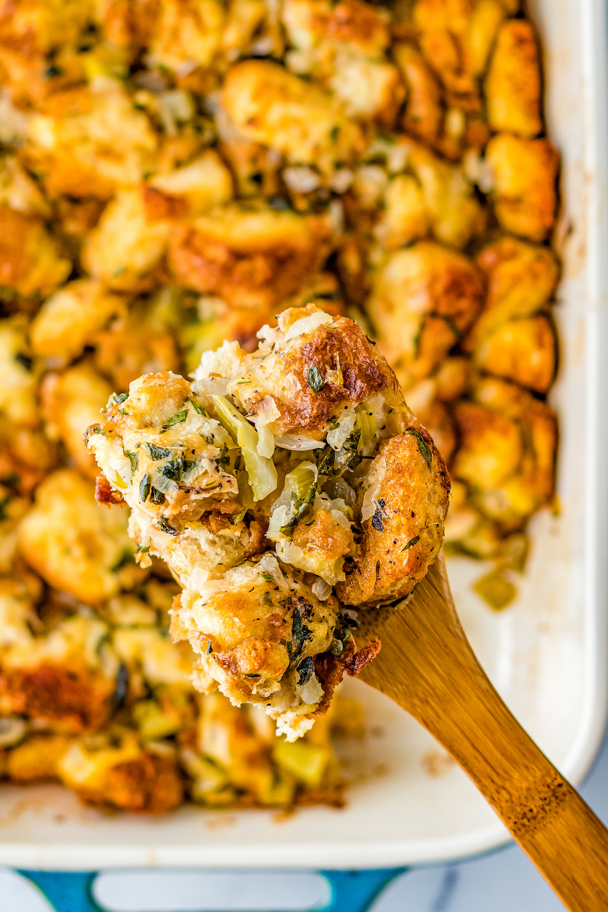 Homemade stuffing on a wooden spatula.