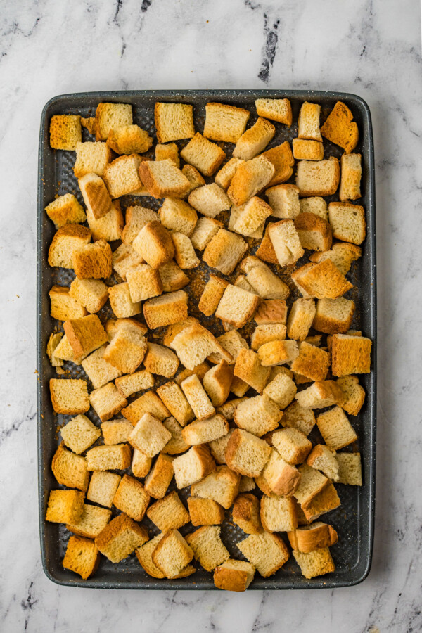 Texas toast cubes on a baking sheet.