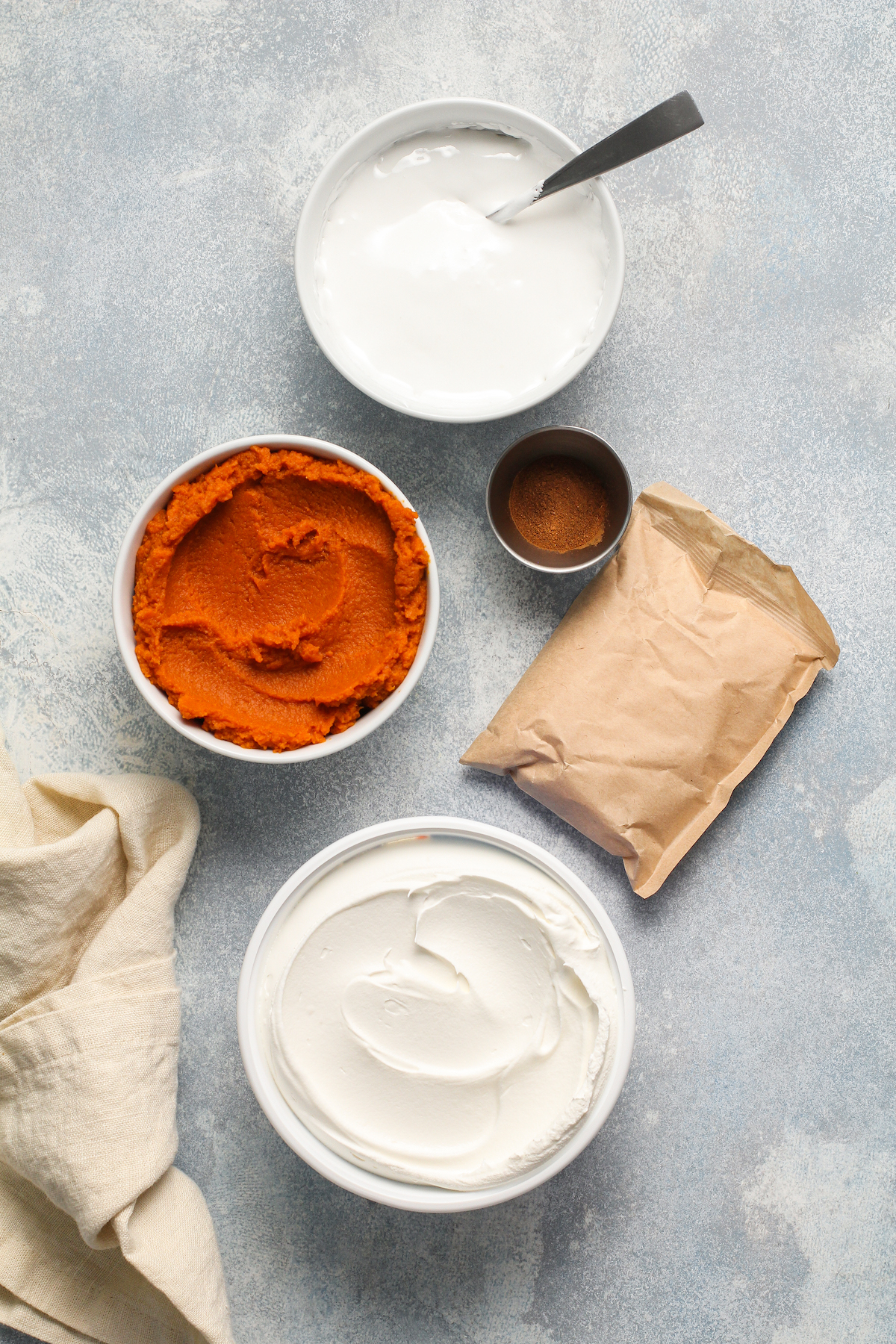 Pumpkin spice, pudding, marshmallow fluff and pumpkin in bowls