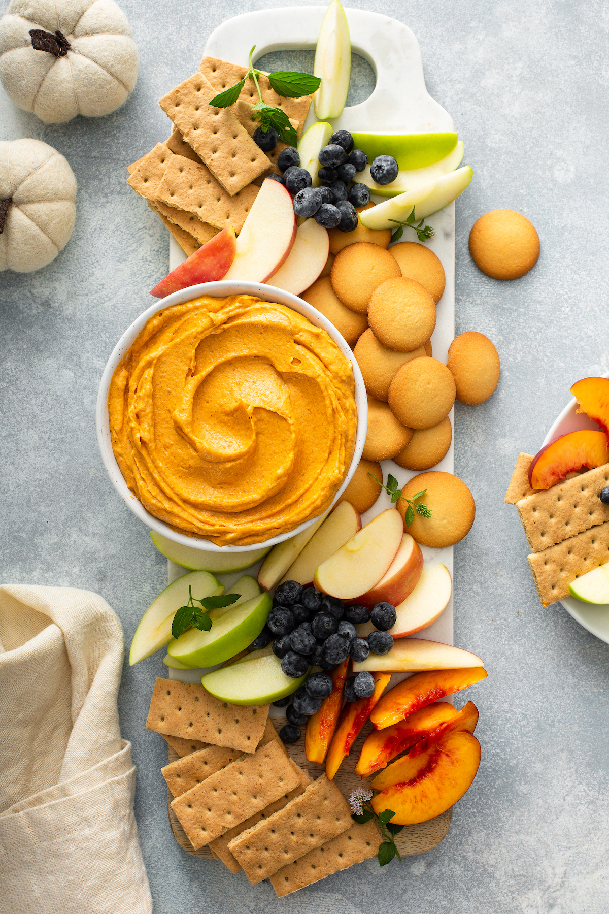 Pumpkin dip served with crackers, fruit and cookies