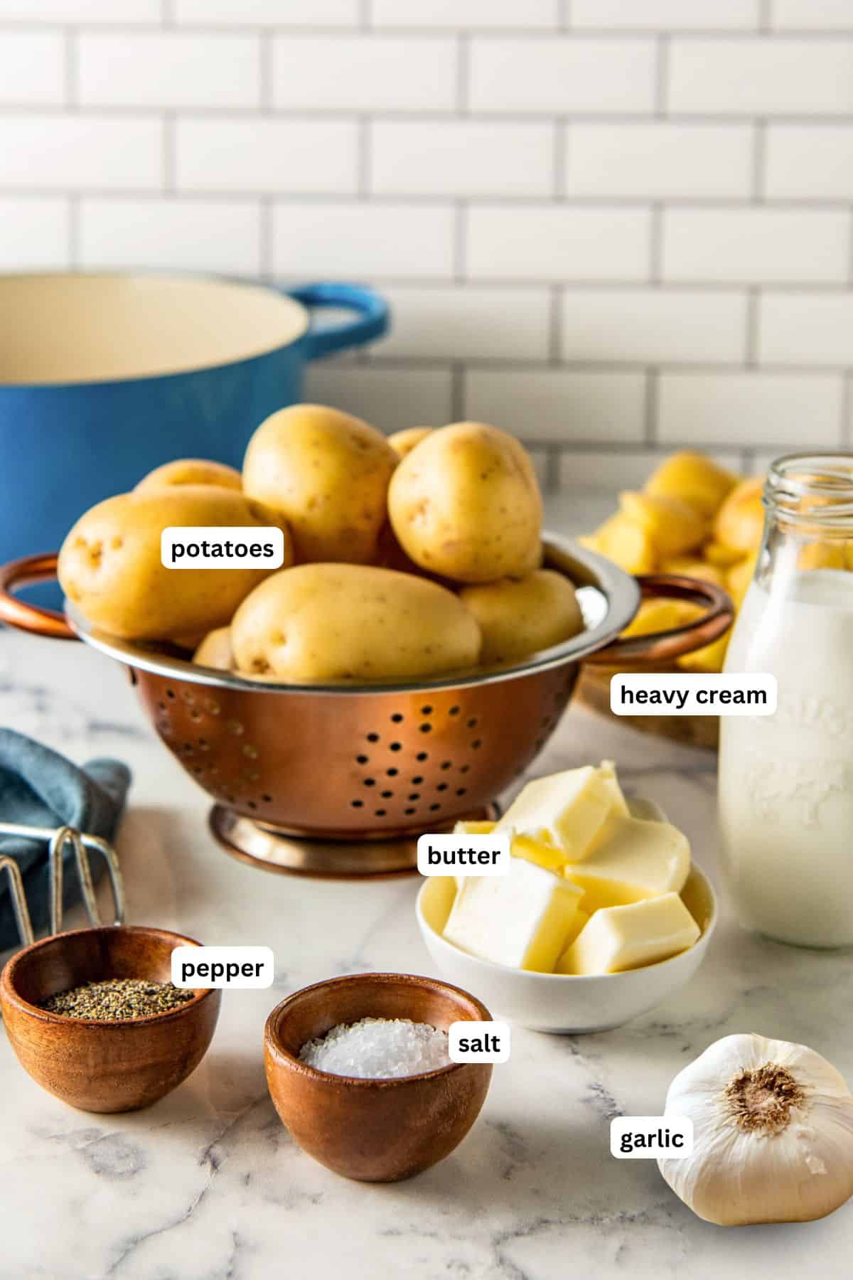 Ingredients for garlic mashed potatoes recipe in order from top to bottom: potatoes, heavy cream, butter, pepper, salt, garlic.