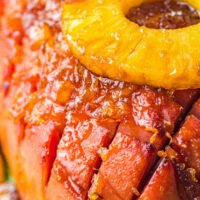 A close-up shot of the crispy, diamond-scored top of an air-fried ham with pineapple glaze.