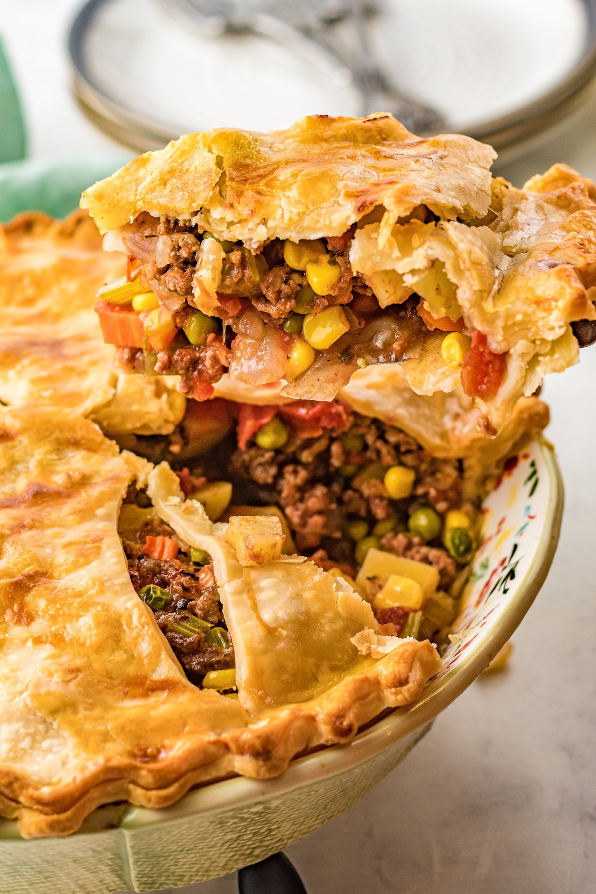 Beef pot pie with a slice being cut and lifted out.