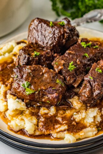 Braised short ribs with red wine sauce on a bed of mashed potatoes.