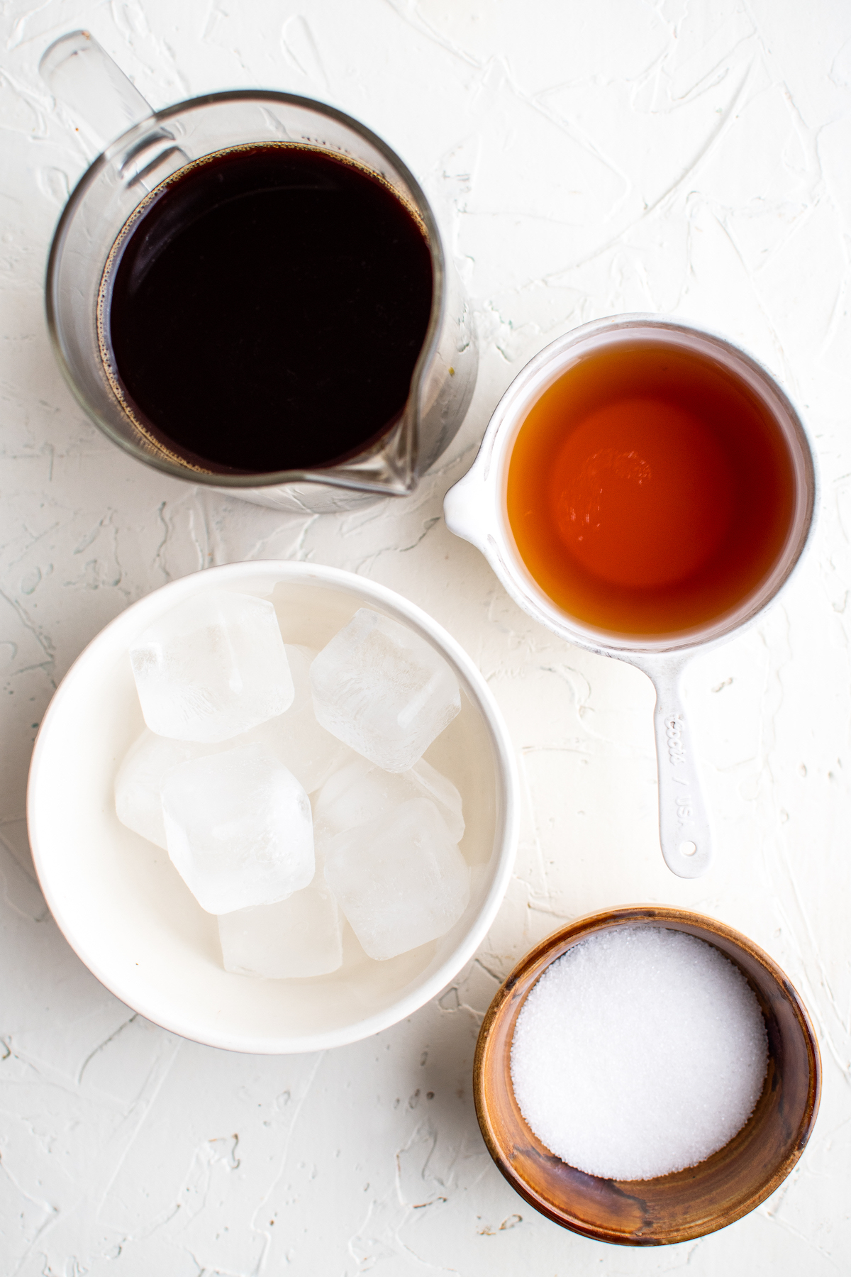 Clockwise from top: Brewed espresso, Licor 43, sugar, ice.
