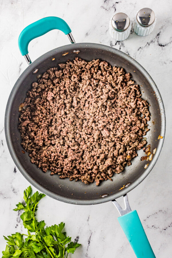 A skillet of browned ground beef.