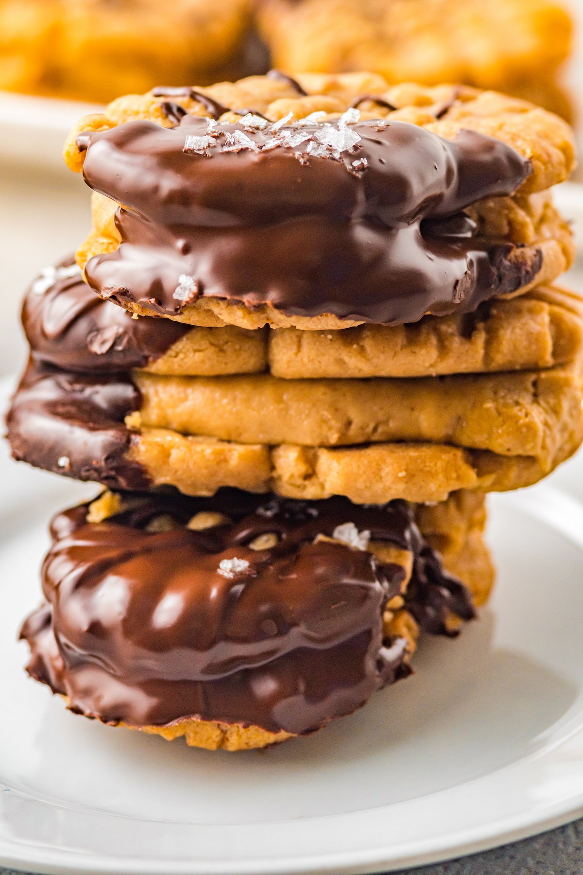Three chocolate dipped Nutter Butter sandwich cookies, stacked on top of each other.
