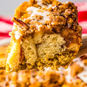 A slice of pumpkin French toast casserole on a spatula.