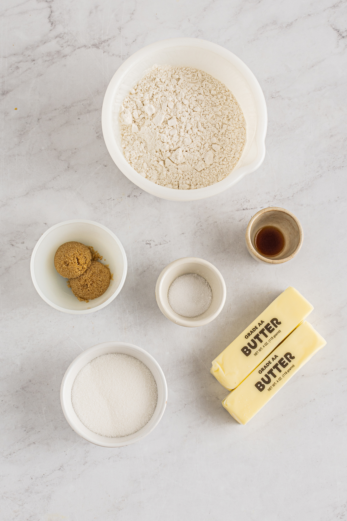Clockwise from top: Flour, vanilla, butter, salt, granulated sugar, brown sugar, all-purpose flour.