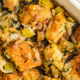 Up close image of the top of homemade stuffing in a casserole dish.