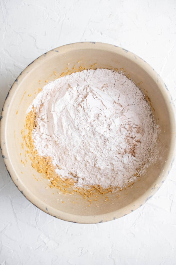 A bowl with flour and other ingredients to make cookies.