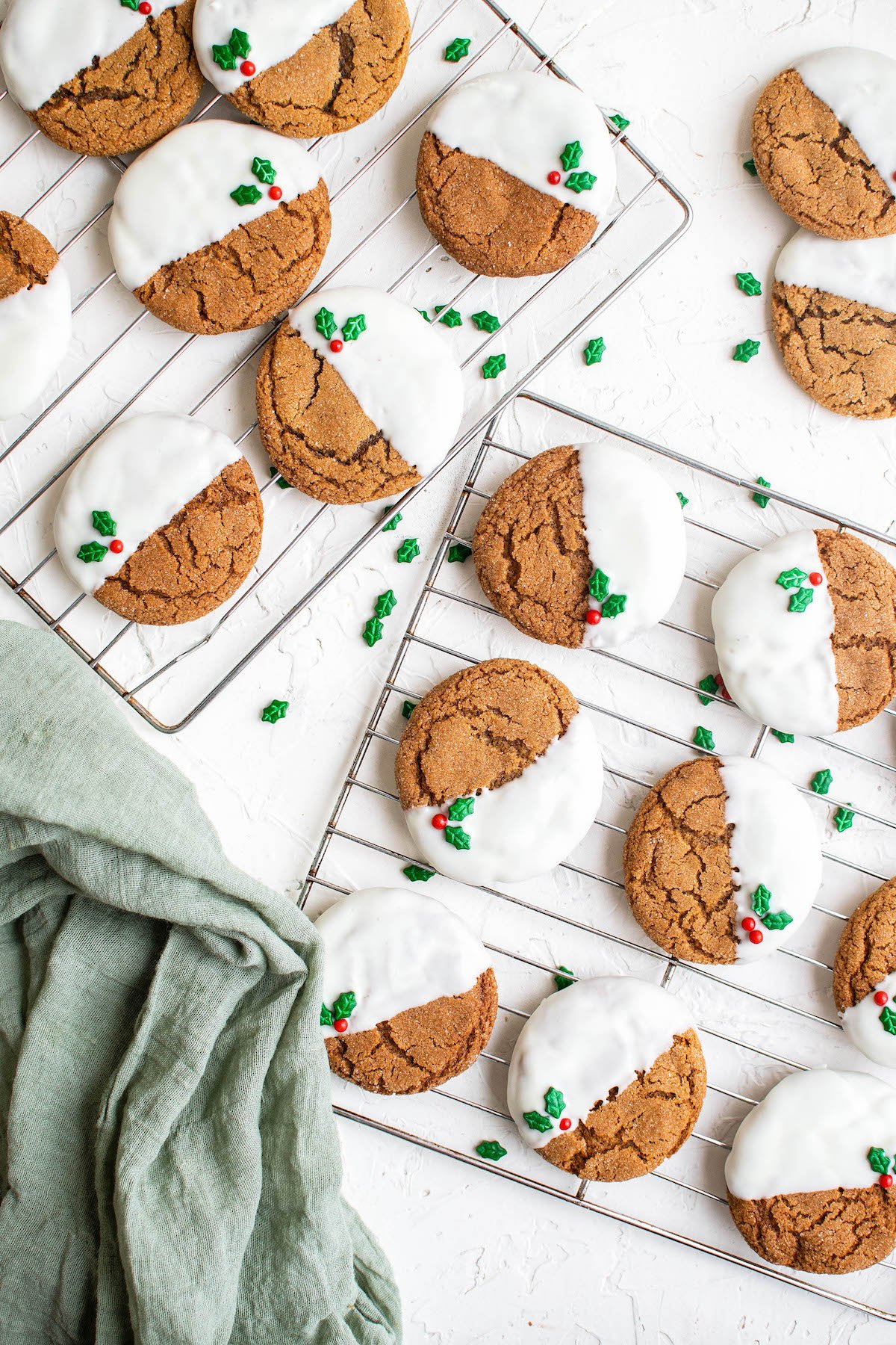 Overhead image of White Chocolate Gingersnap Cookies on a cooling cookie rack with a tea towel.