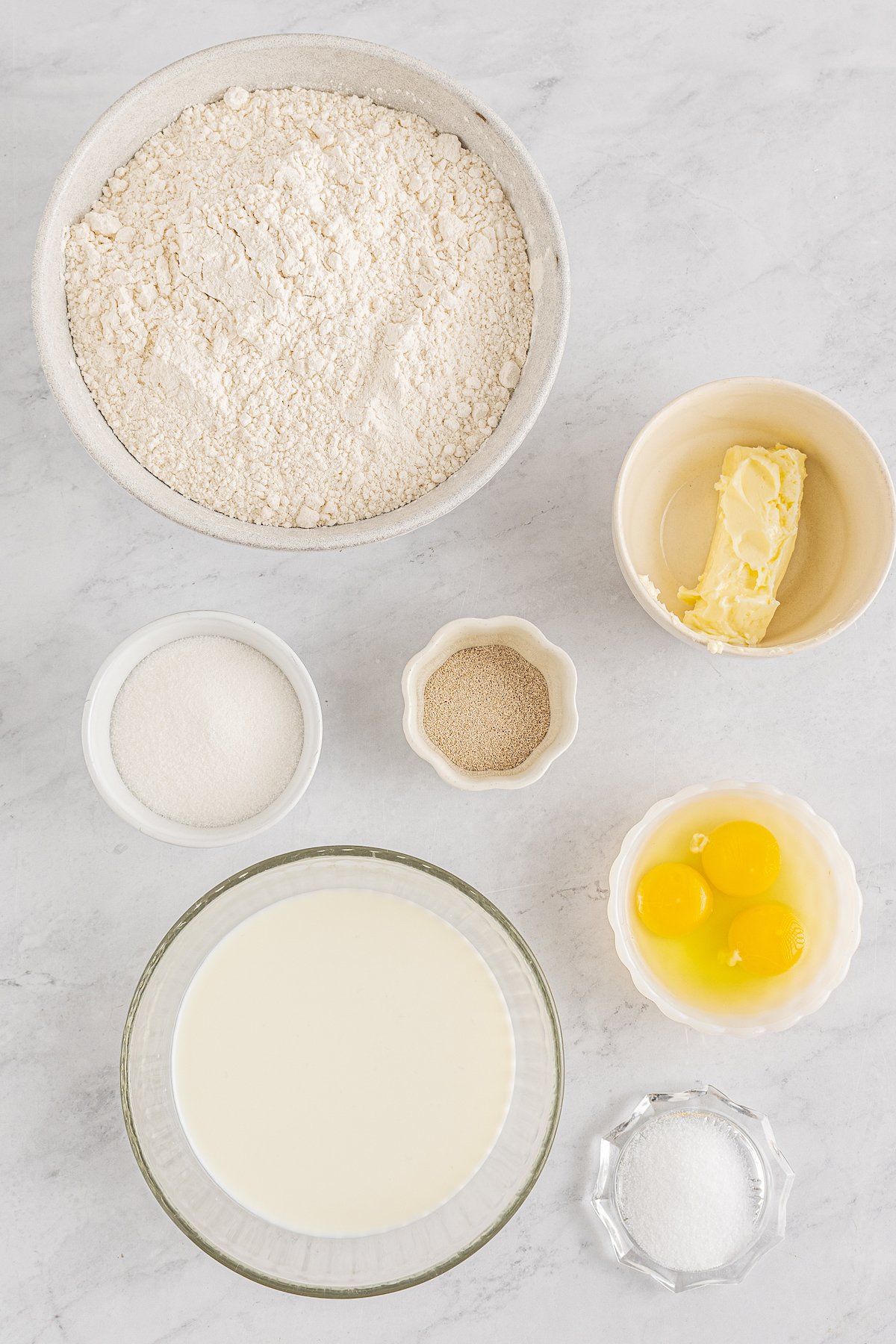 Clockwise from top: Flour, softened butter, yeast, eggs, milk, sugar.