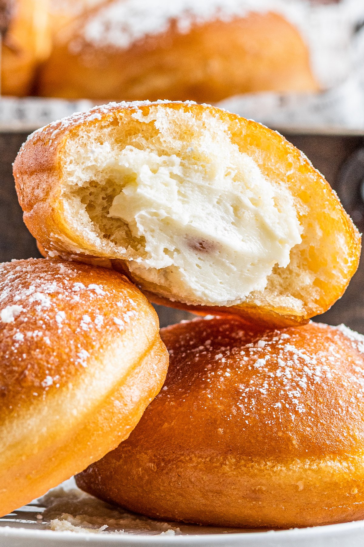 Close-up shot of three cream-cheese-filled donuts.