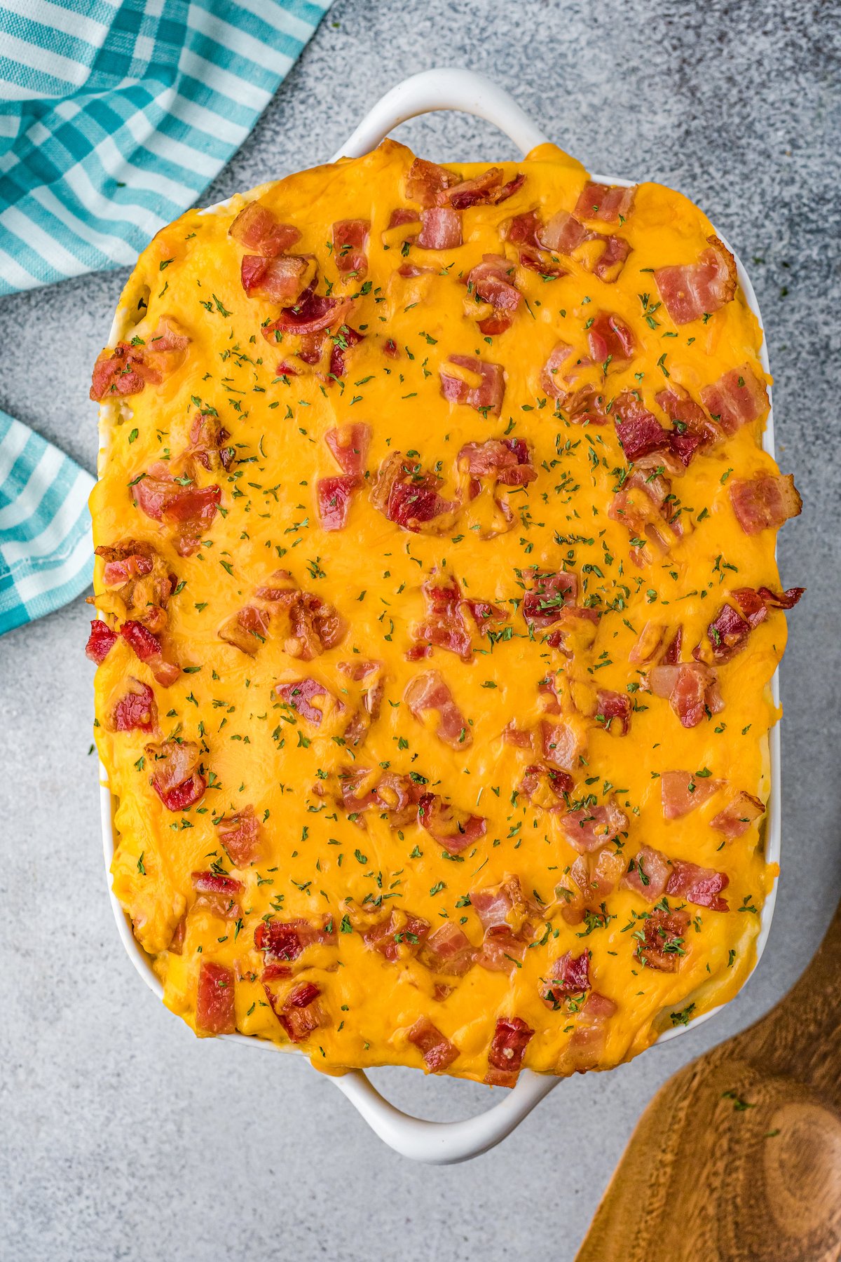 Overhead shot of a baked meatloaf casserole, topped with cheddar and bacon.
