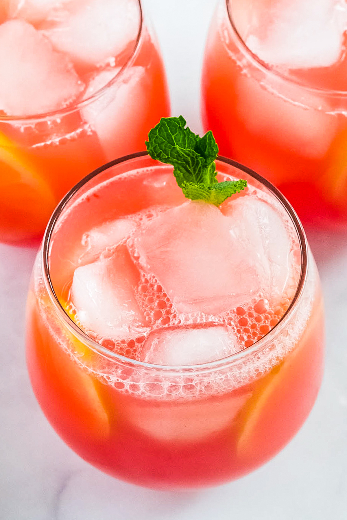 Close-up shot of watermelon lemonade in a stemless wine goblet.