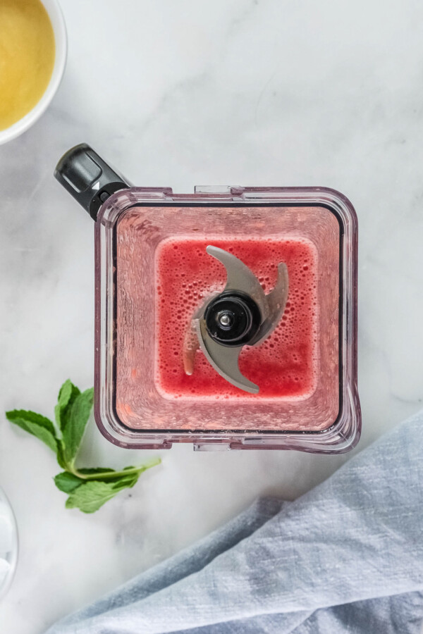 Overhead shot of a blender with pureed watermelon inside.