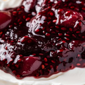 Chia cherry jam on top of yogurt on a piece of toast.