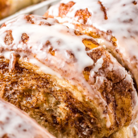 Cinnamon bread with icing torn into pieces to see the inside.
