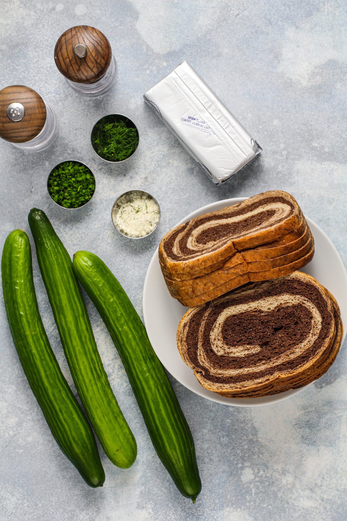 From top left: Salt, pepper, chives, dill, cream cheese, ranch seasoning, bread, cucumbers.