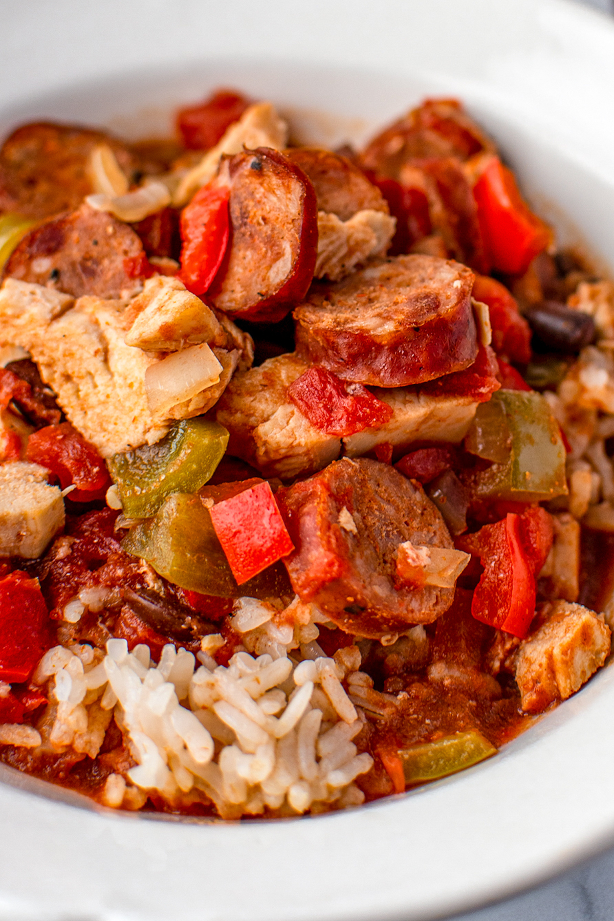 Close-up shot of cajun chicken and sausage over rice.