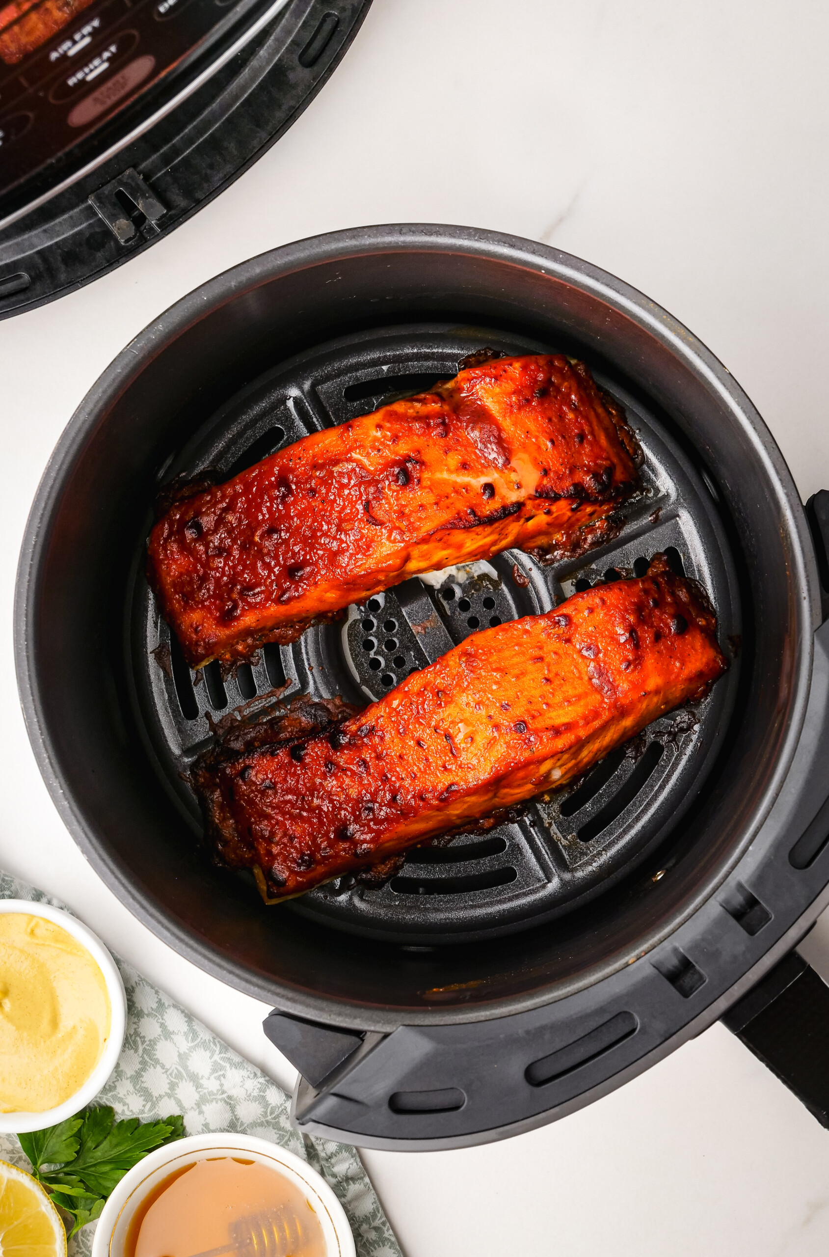 Cooked fish fillets in an air-fryer.