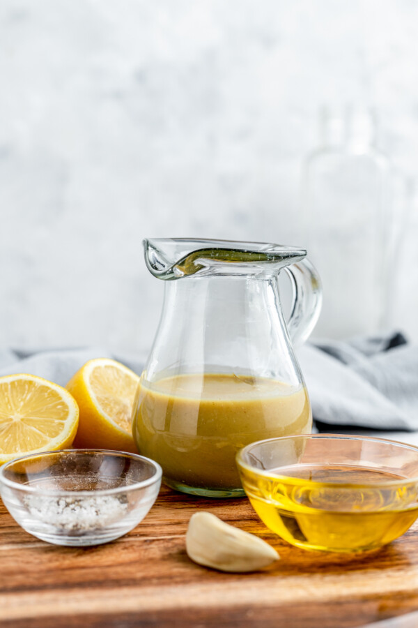 Honey mustard salad dressing in a small glass pitcher.