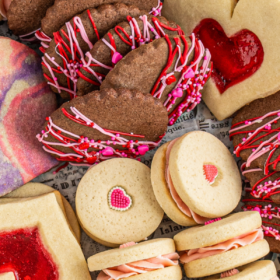 Overhead image of assorted Valentine's Day cookies in a red cookie tin.