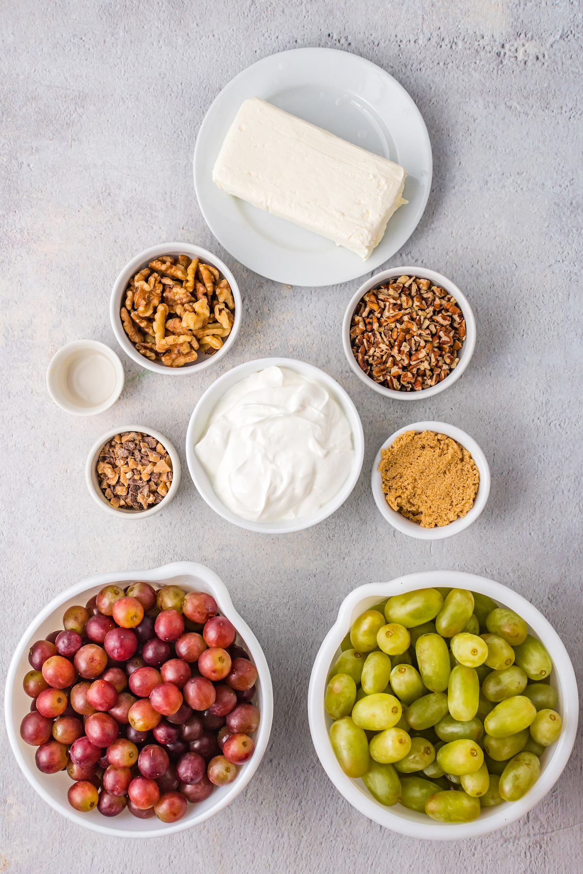 From top: Cream cheese, chopped pecans, chopped walnuts, vanilla, Heath crumbles, sour cream, brown sugar, red grapes, green grapes.