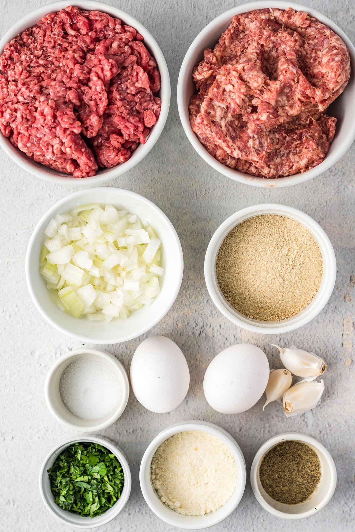 From top: ground beef, ground pork, onion, bread crumbs, salt, eggs, garlic, parsley, parmesan, pepper.