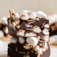 Two squares of homemade rocky road fudge stacked on top of each other.