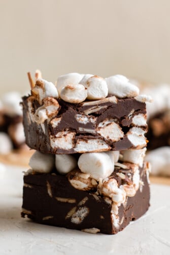 Two squares of homemade rocky road fudge stacked on top of each other.