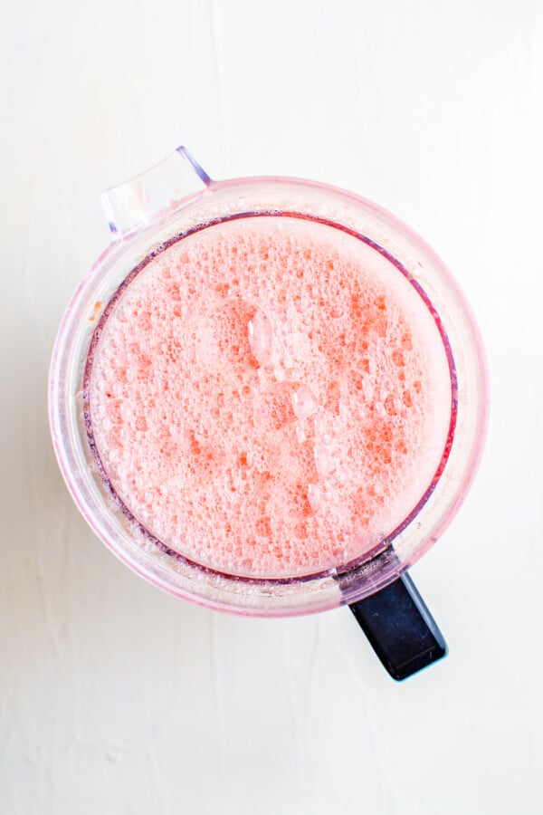 Frothy, pureed watermelon in a blender.