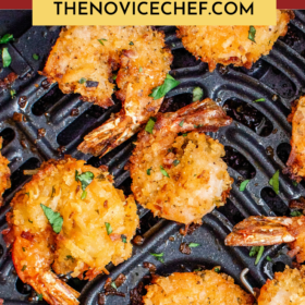 Coconut Shrimp in an air fryer basket with parsley on top.