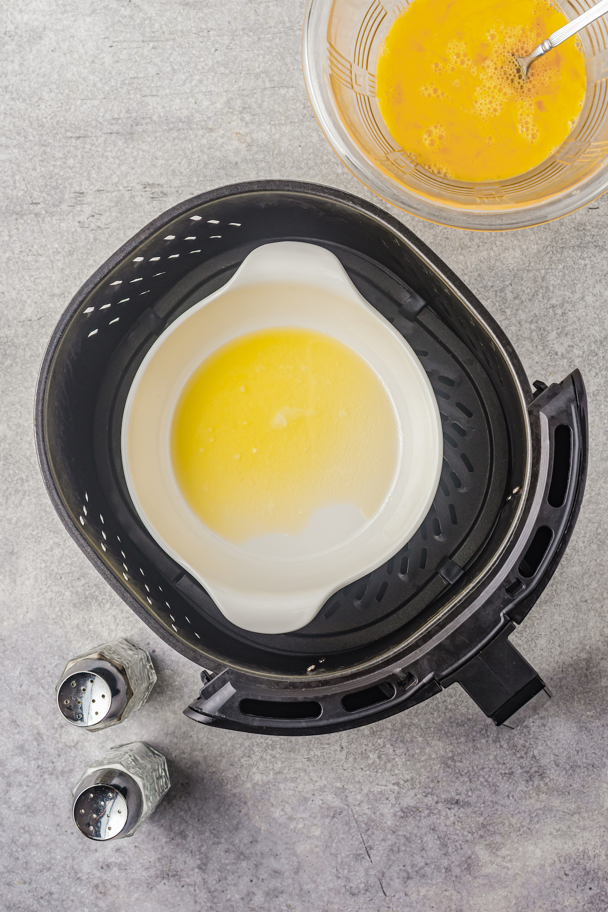 Butter is melted in a pot inside an air fryer.