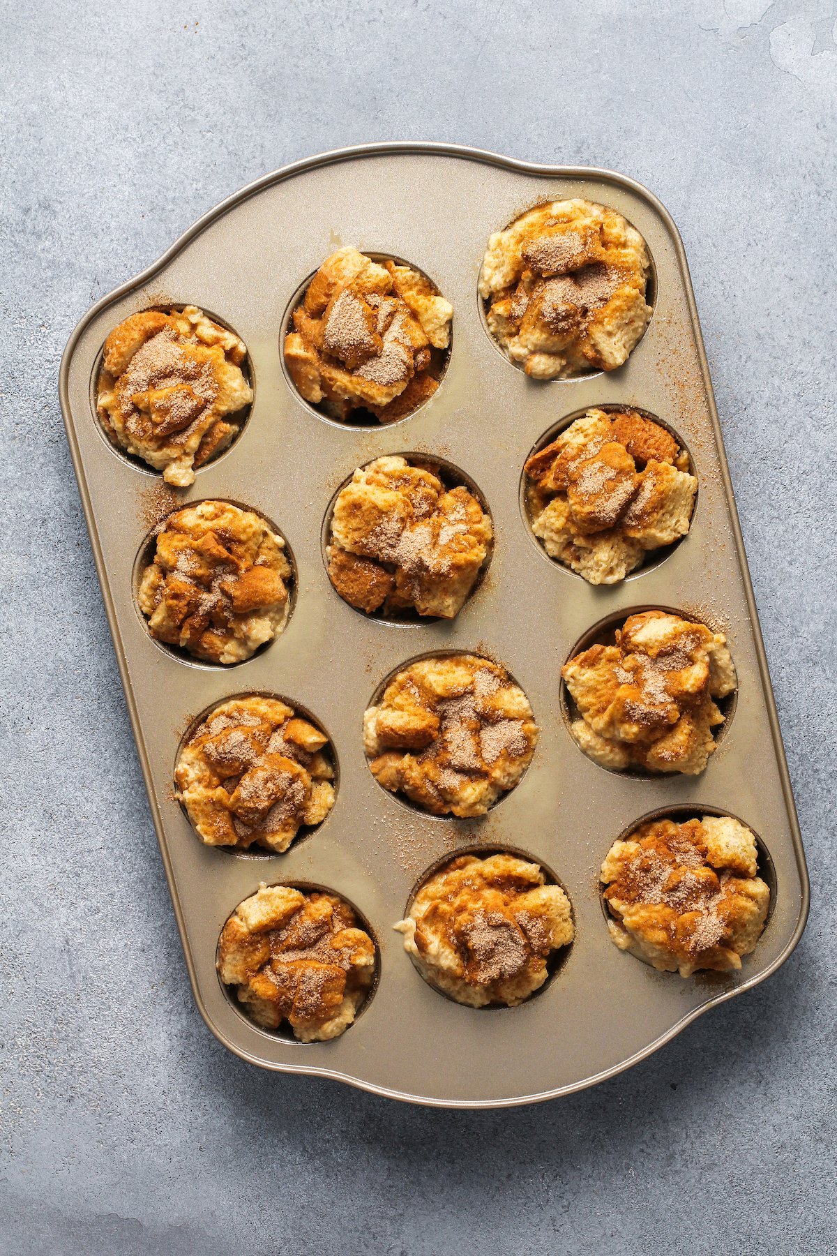 Baked french toast muffins in a muffin tin.