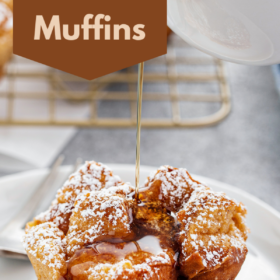 French toast muffin with powdered sugar on top and maple syrup being poured on top.