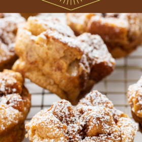 French toast muffins sprinkled with powdered sugar on a cooling rack.