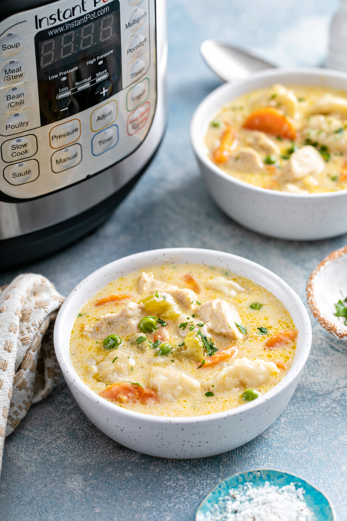 Instant pot chicken and dumplings in white bowls.